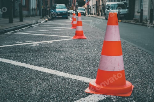 Preview: Orange and white traffic cones line up on a road with solid line markings