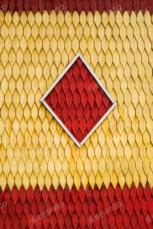 Preview: Old weathered wooden wall with ornament painted in red and yellow. Vintage texture Background.