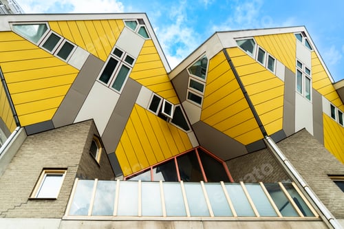 Preview: Low angle view of the yellow geometric facades of the Cube Houses in Rotterdam