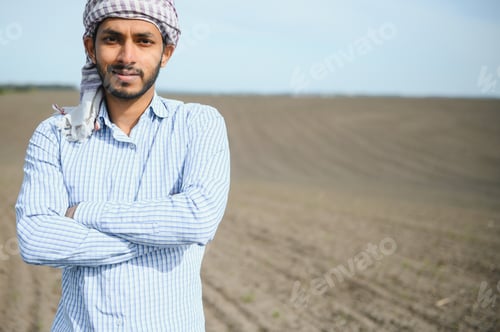 Preview: Young indian farmer at agriculture field.