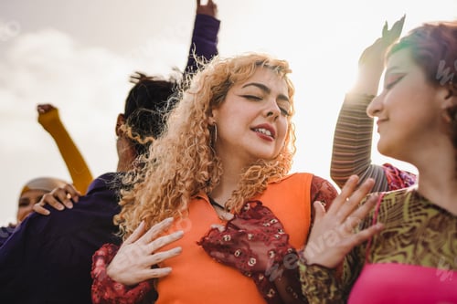 Preview: Happy young people dancing at music concert outdoor