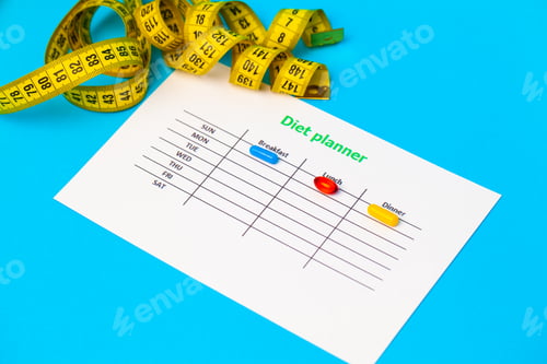 Preview: Diet plan and weight loss pills on blue background.