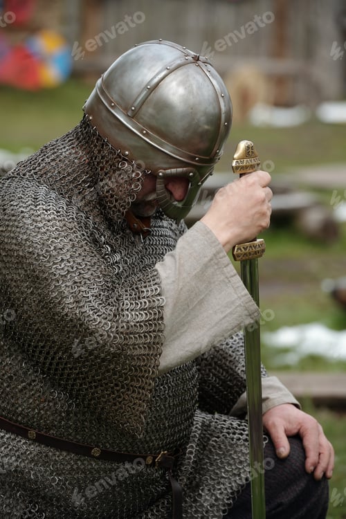 Preview: Bowing Medieval Knight in Chainmail Armor Holding Sword