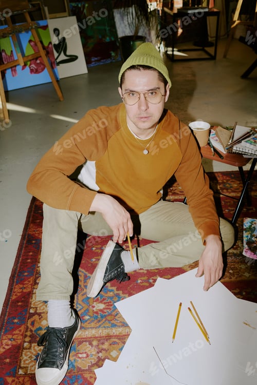Preview: Male Artist Sitting On Vintage Carpet