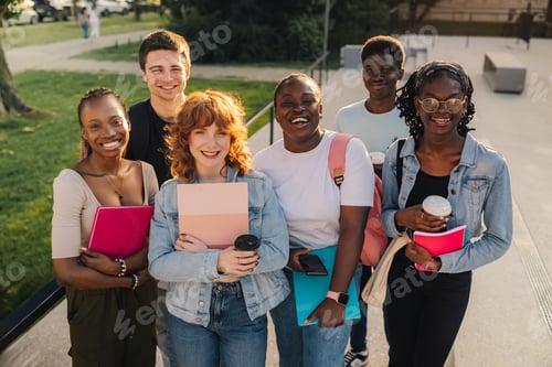 Preview: Diverse group of happy students at university campus smiling at camera