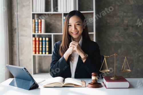 Preview: Attractive young lawyer in office Business woman and lawyers discussing contract papers with brass s
