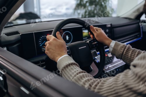 Preview: By steering wheel. Man is sitting in car, detailed view