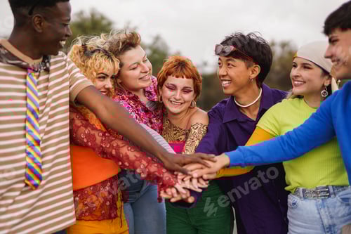 Preview: Group of multiracial young people stacking hands outdoor