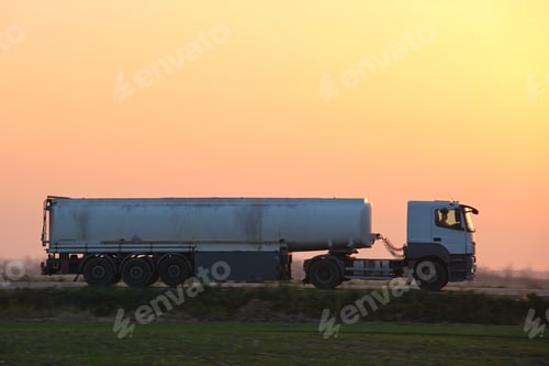 Preview: Semi-truck with tipping cargo trailer transporting sand from quarry driving on highway