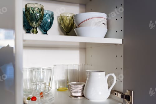 Preview: Clean dishes and tableware on white shelf