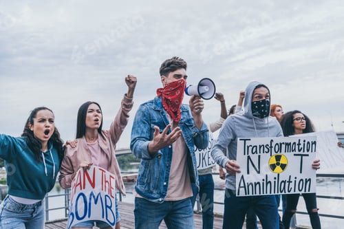 Preview: men with scarfs on faces gesturing near multicultural people with placards