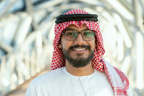 Preview: A man wearing a red and white head scarf and eyeglasses