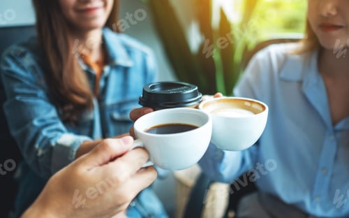 Preview: A group of young people enjoyed drinking and clinking coffee cups in cafe