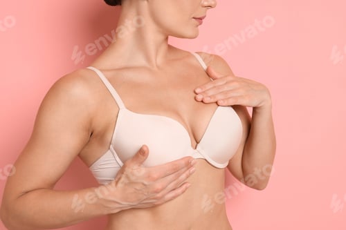 Preview: Woman wearing beautiful beige bra on pink background, closeup