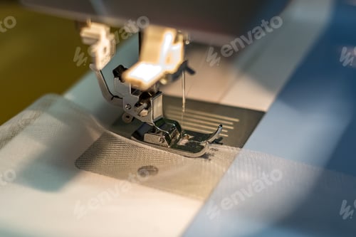 Preview: close up mechanism of sewing machine foot with needle and thread