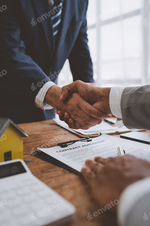 Preview: Real estate broker and client shaking hands after signing sale contract, home loan and congratulatin
