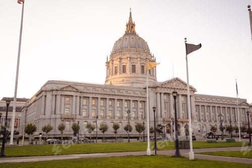 Preview: Low-angle shot of the San Francisco city hall against the bright white sky during the daytime