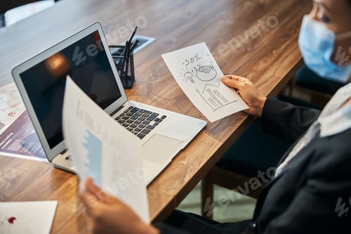 Preview: Close up of serious businesslady doing analysis of diagrams