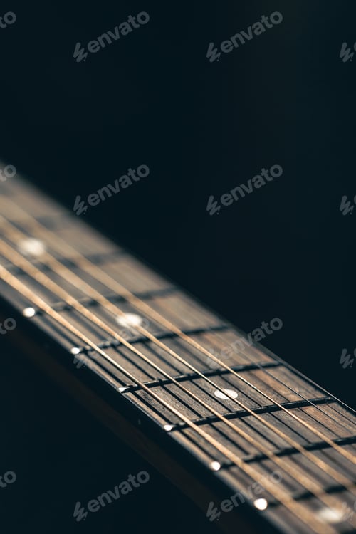 Preview: Part of an acoustic guitar, guitar fretboard on a black background.