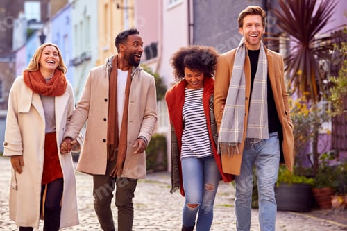 Preview: Multi Cultural Couple With Friends Walking Along Residential City Street In Fall Or Winter
