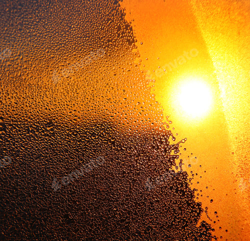 Preview: Nature background with bright sunlight, water drops and ice pattern on glass