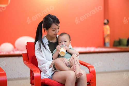 Preview: Mother take care her son drinking milk