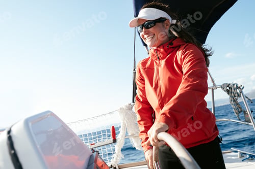 Preview: Attractive strong woman sailing with her boat