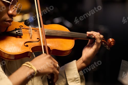 Preview: Young Adult Black Man Playing Violin during Musical Performance Indoors