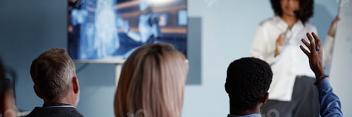 Preview: Header Image of Black Man Raising Hand to Ask Question at Business Meeting