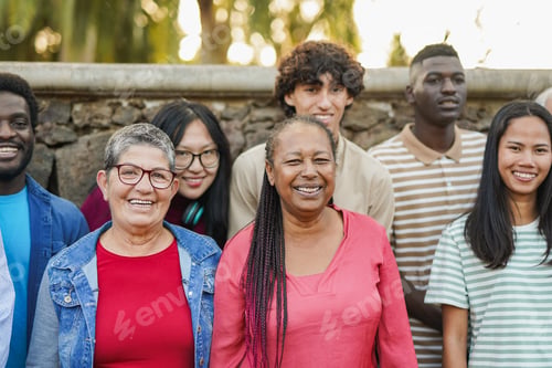 Preview: Crowd of multiracial people with different ages smiling on camera at city park