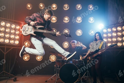 Preview: Guitarist plays on bas-guitar, snapshot in a jump