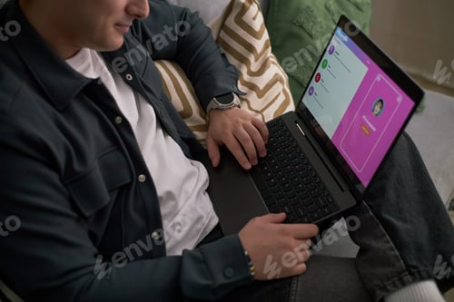 Preview: Young Adult Caucasian Man Using Laptop for Online Dating at Home