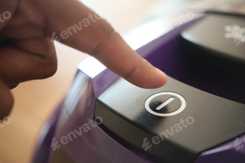 Preview: pressing start button on vacuum cleaner.