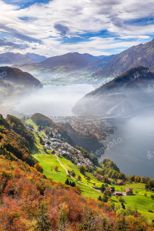 Preview: Fabulous autumn view of Stansstad city and Lucerne lake with mountaines and fog.