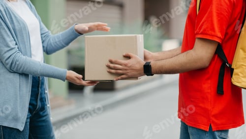 Preview: Quarantine and online delivery service. Woman takes on parcel from courier with smart watch and