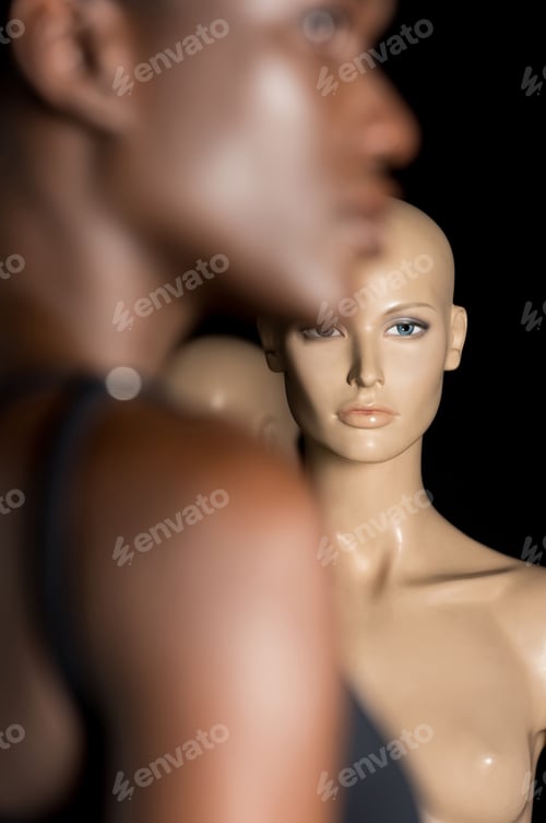Preview: selective focus of young african american woman standing near dummies on black