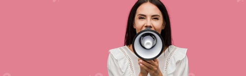 Preview: panoramic shot of woman screaming in megaphone isolated on pink