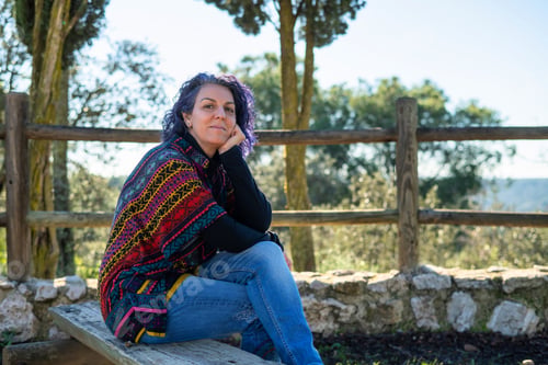 Preview: Mature woman enjoying freedom outdoors in nature park