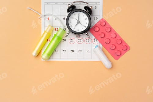 Preview: Female medical tampons and painkiller pills top view