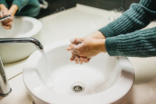 Preview: The girl carefully washes her hands with soap