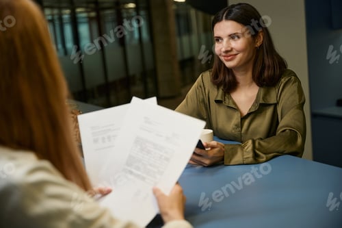 Preview: Business woman discussing deal with papers