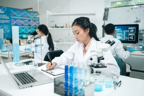 Preview: Medical research teamwork in laboratory using microscope and blood test tubes for DNA analysis