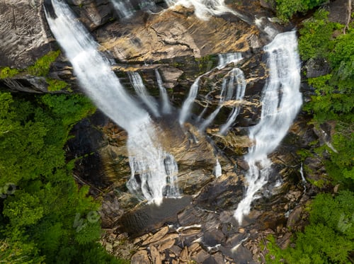 Preview: Beautiful landscape of high waterfall with falling down clear water from rocky boulders