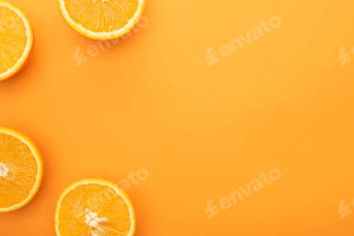 Preview: top view of ripe juicy orange slices on colorful background with copy space