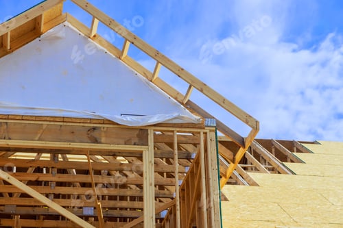 Preview: Installation of plywood on wooden roofing trusses at house under construction after a roof has been