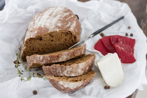 Preview: Fresh bread, cheese and prosciutto on table