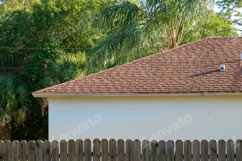 Preview: Closeup of house roof top covered with asphalt or bitumen shingles. Waterproofing of new building