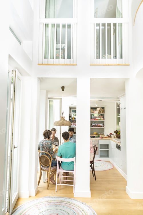 Preview: Rear view of five adult friends dining at dining table