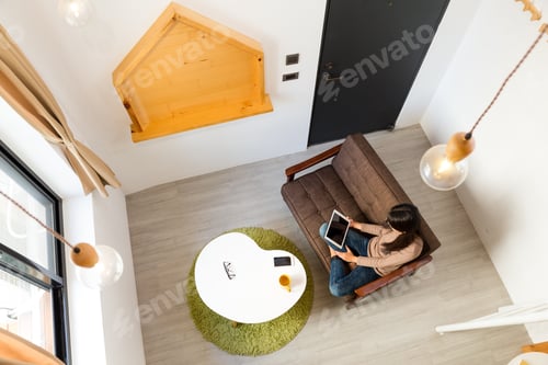 Preview: Top view of woman use of the tablet pc
