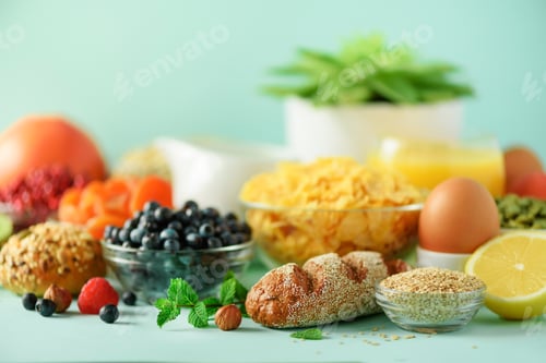 Preview: Delicious breakfast ingredients. Soft boiled egg, oat flakes, nuts, fruits, berries, milk, yogurt